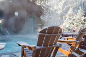 adirondack chairs by a heated pool