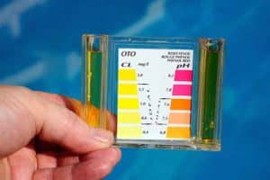 Man checking the chemical balance of a swimming pool, Costa del Sol, Andalucia, Spain, Western Europe.